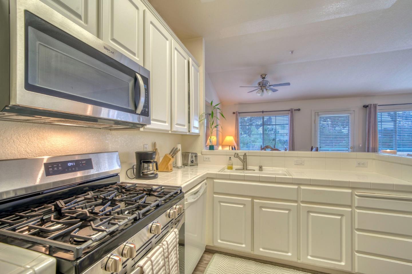 121 Skyline Drive San Ramon, CA 94583 - Photo 7 of 38 a kitchen with stainless steel appliances granite countertop a stove and a microwave