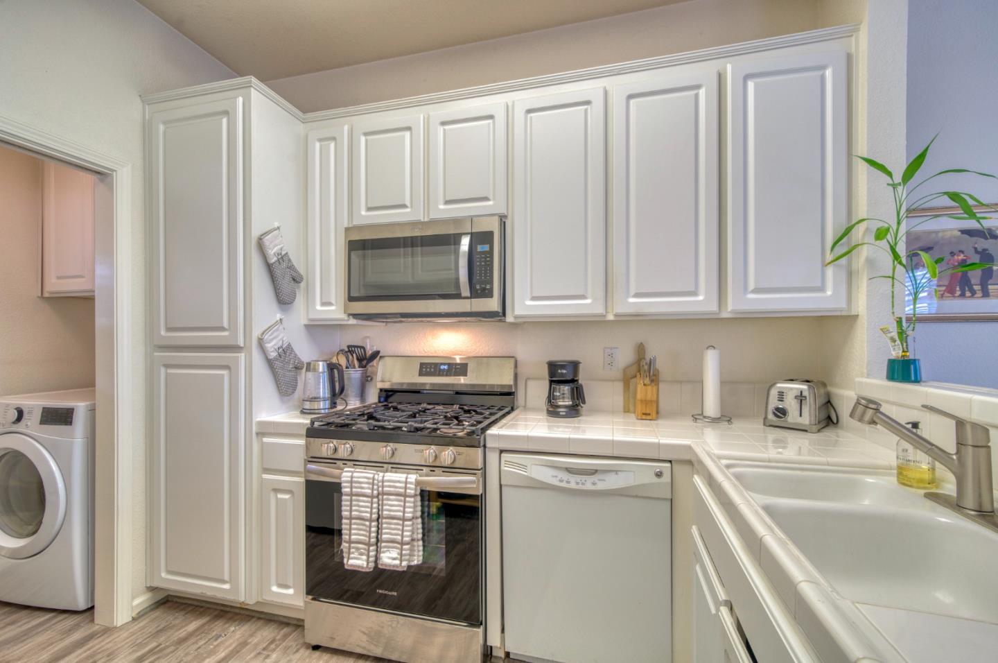 121 Skyline Drive San Ramon, CA 94583 - Photo 8 of 38 a kitchen with stainless steel appliances a stove a sink a refrigerator a microwave a stove and cabinets
