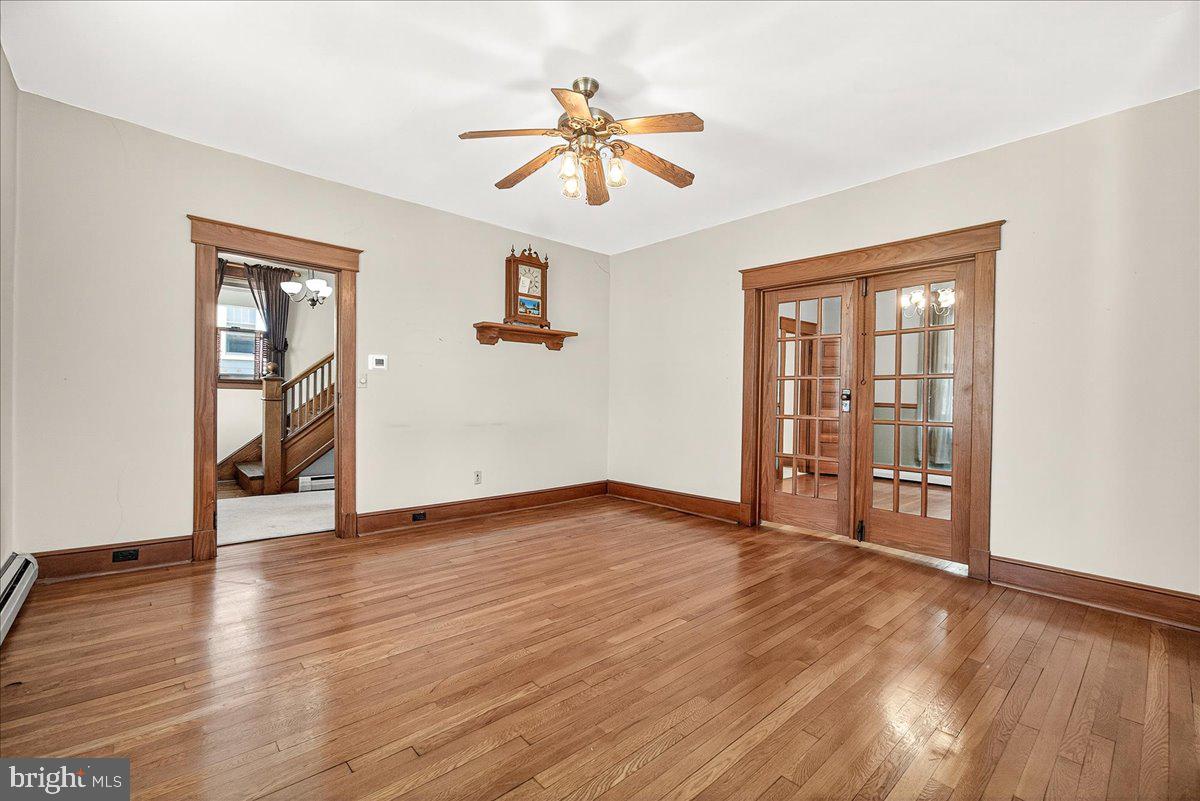 206 Prospect Street Middletown, MD 21769 - Photo 11 of 47 an empty room with wooden floor chandelier and windows