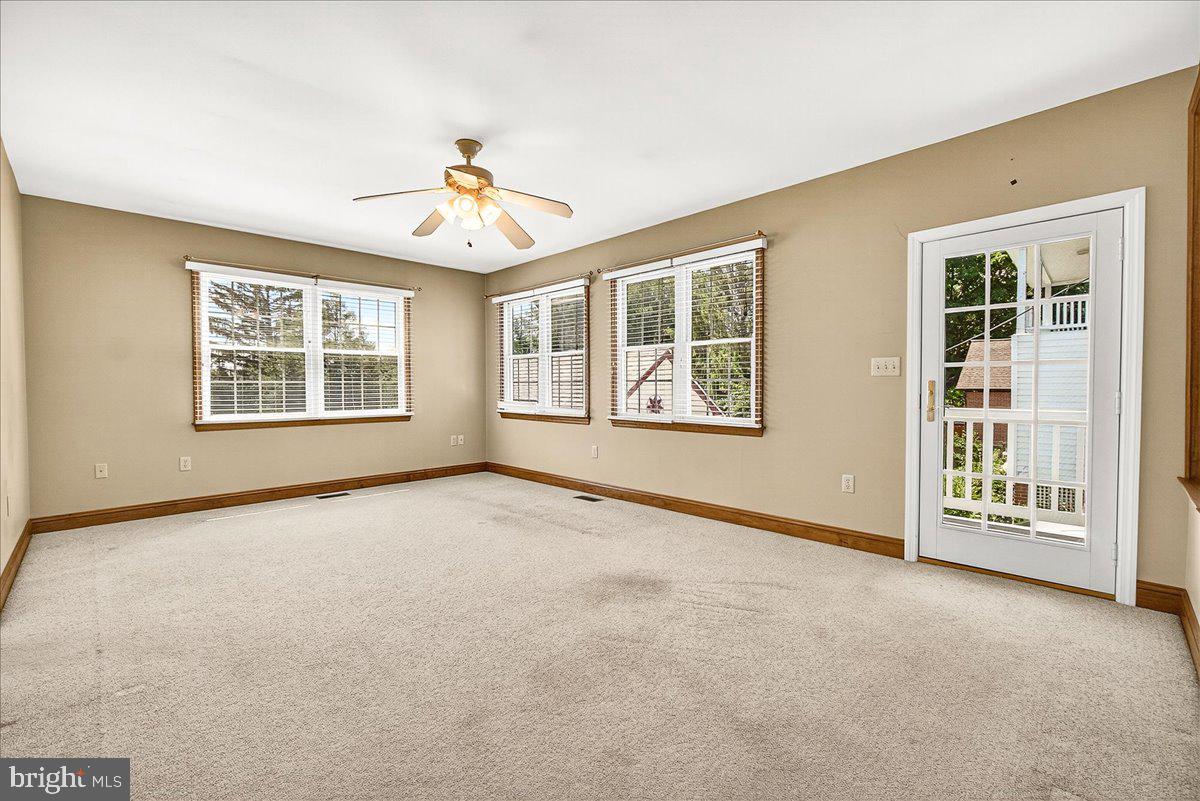 206 Prospect Street Middletown, MD 21769 - Photo 25 of 47 an empty room with chandelier fan and windows