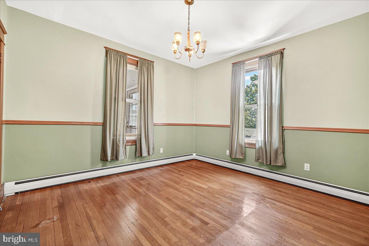 206 Prospect Street Middletown, MD 21769 - Photo 9 of 47 an empty room with wooden floor and windows