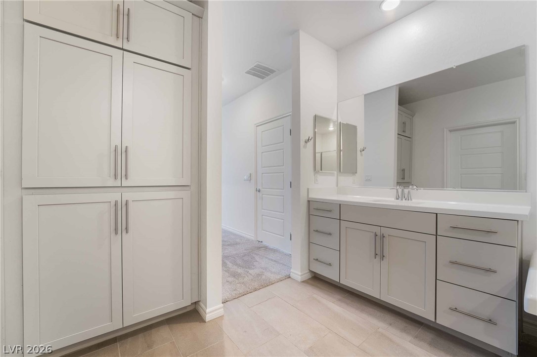 2555 Hampton Road, Unit 10202 Henderson, NV 89052 - Photo 33 of 35 Ample built-in cabinetry and tile flooring elevate this modern bathroom design.