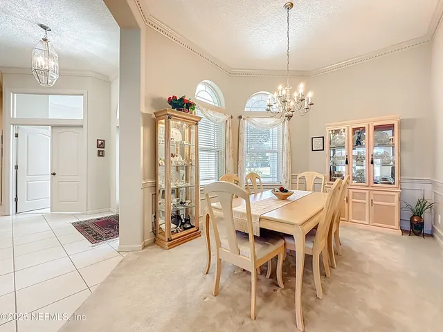 a living room with furniture gym equipment and a chandelier