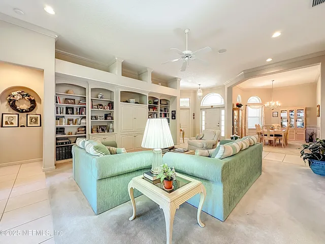 a living room with dining room and kitchen view