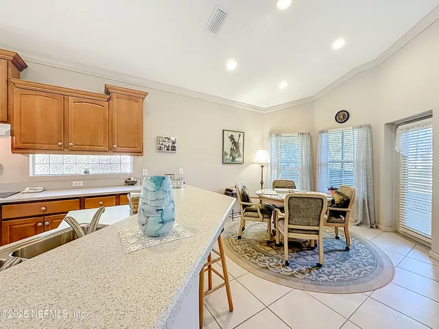 a view of a dining room with furniture and window
