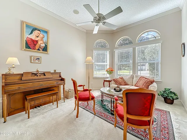a living room with furniture and a chandelier
