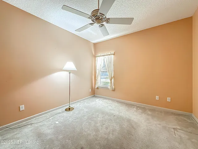 an empty room with a fan