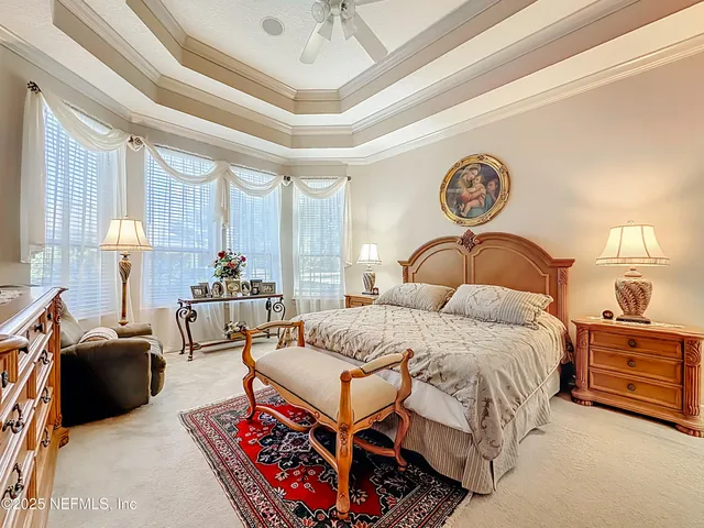 a bedroom with a bed and a chandelier