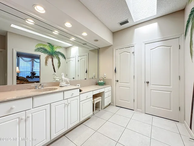 a bedroom with a bed and a dresser with rug