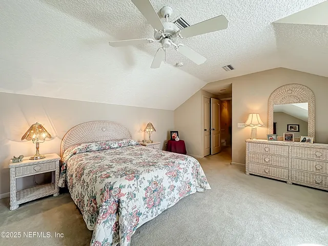 a bed room with a bed mirror and a ceiling fan