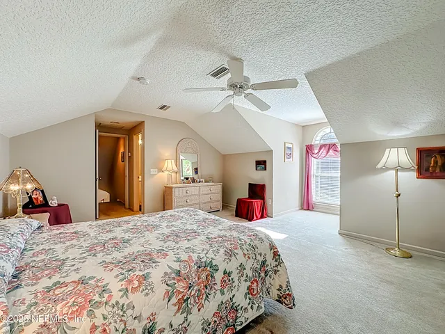 a bathroom with a sink a toilet and shower curtain