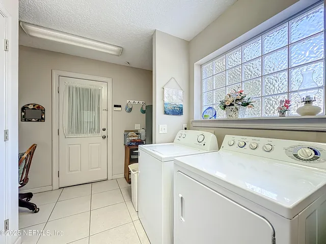 a dining room with furniture and a floor to ceiling window