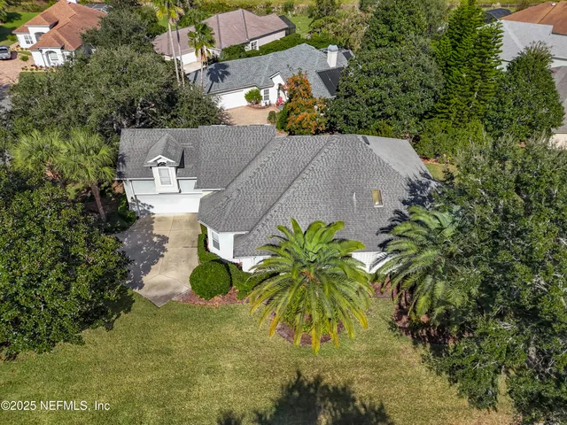 an aerial view of a house with a yard