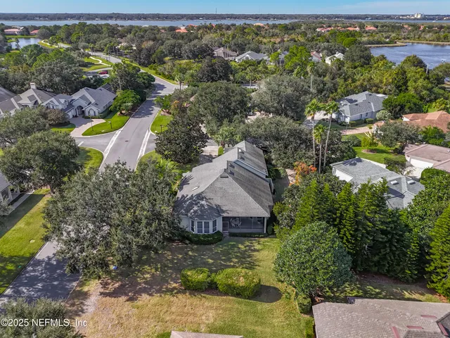 an aerial view of residential houses with outdoor space and swimming pool