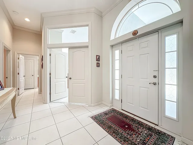 a view of a dining room with furniture and a chandelier