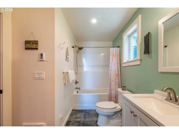 a living room with furniture wooden floor and a large window