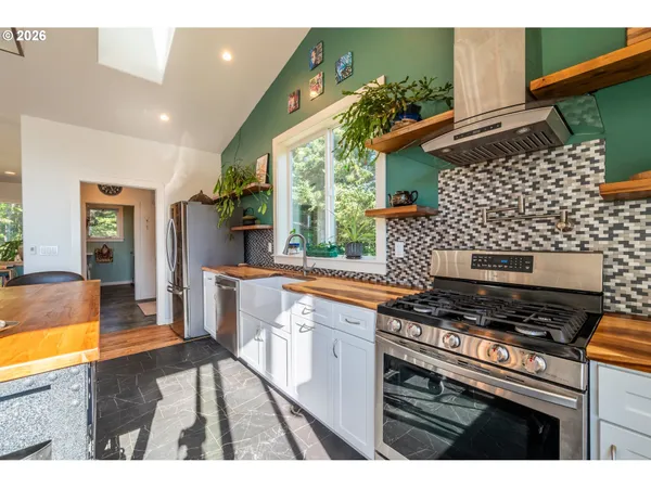 a kitchen with stainless steel appliances a sink and a refrigerator