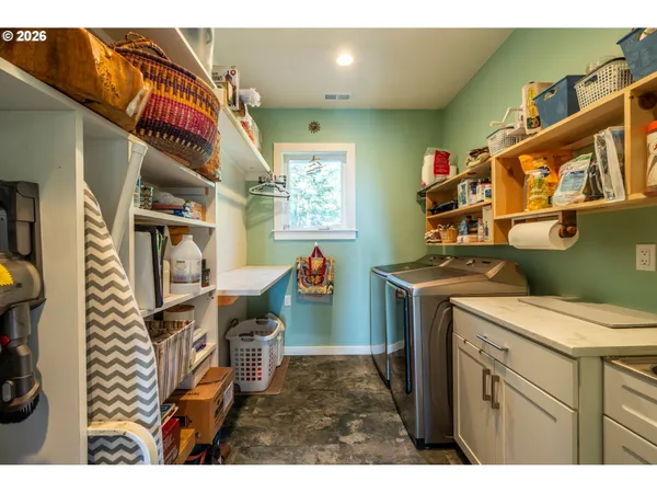a living room with furniture and a book shelf