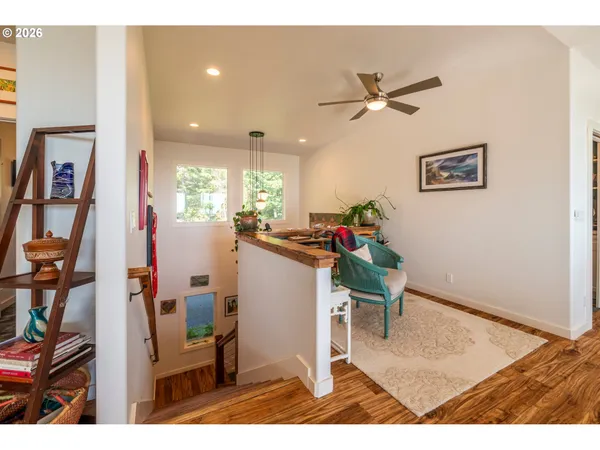 a living room with furniture a large window and a flat screen tv