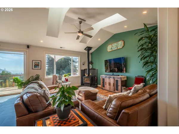 a living room with furniture and a floor to ceiling window