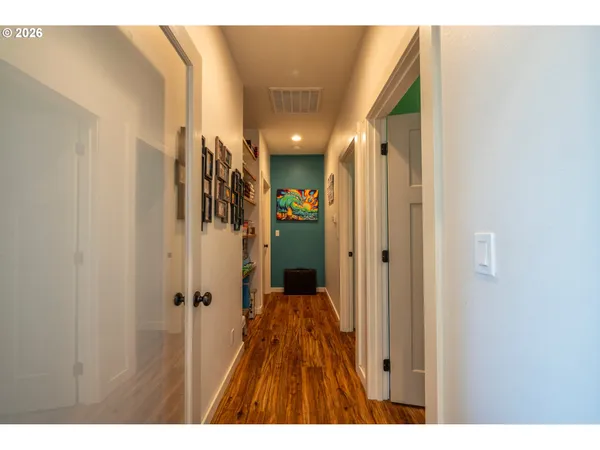 a bedroom with a bed a bookshelf and a window