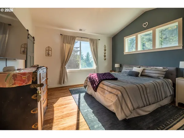 a bedroom with a bed and a window