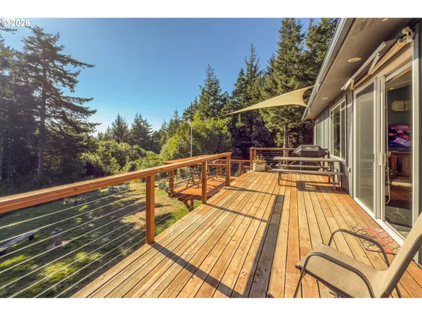 a view of balcony with wooden floor and seating space
