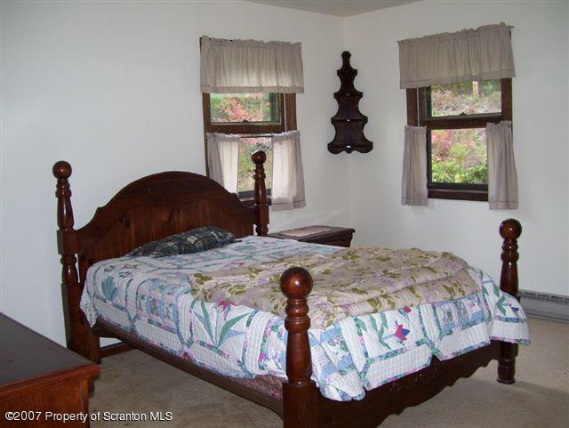 1 Rr Sugar Run Mehoopany, PA 18629 - Photo 5 of 5 a bedroom with a bed and a chandelier