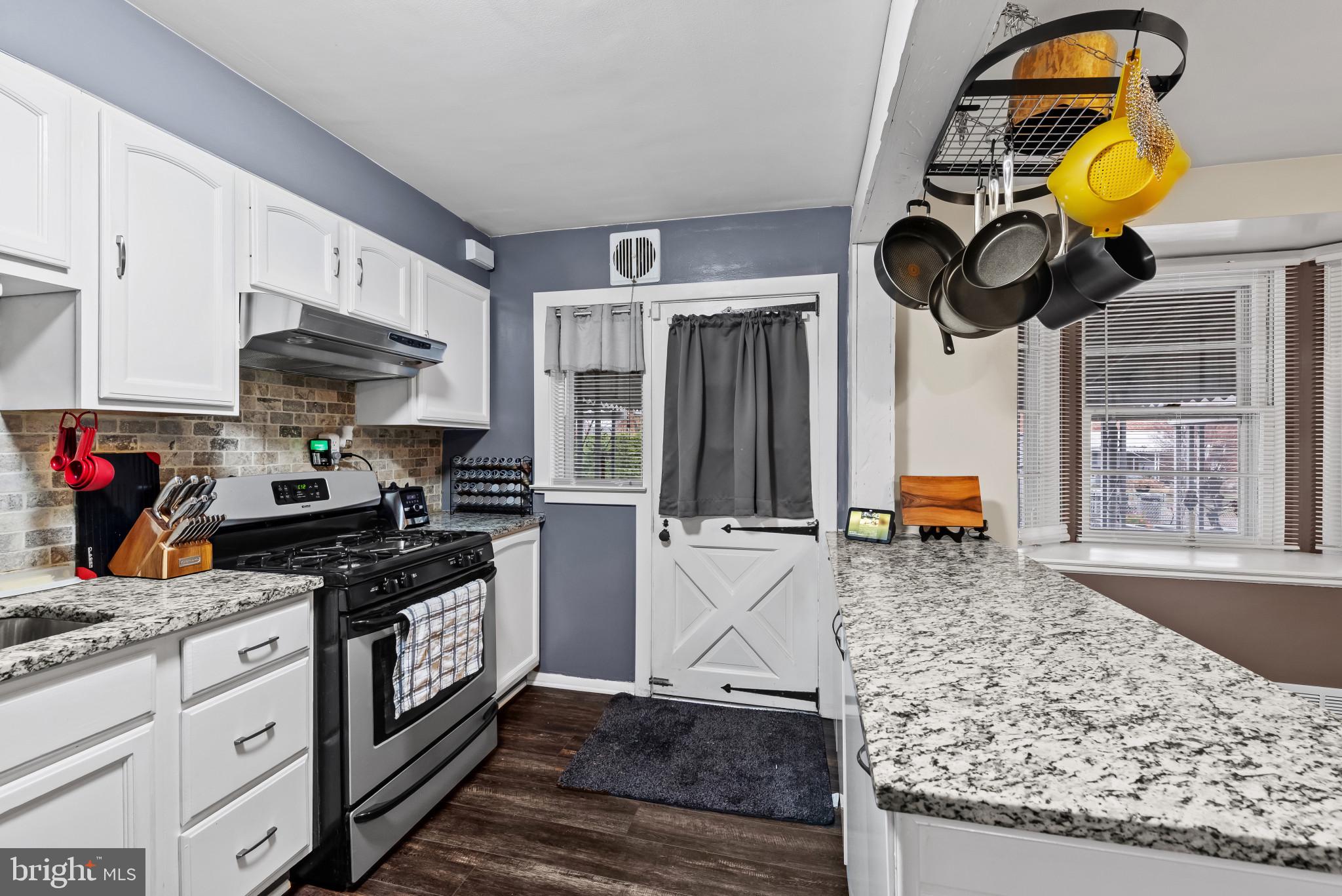 7304 Stratton Way Baltimore, MD 21224 - Photo 11 of 34 Kitchen with white cabinets and an island