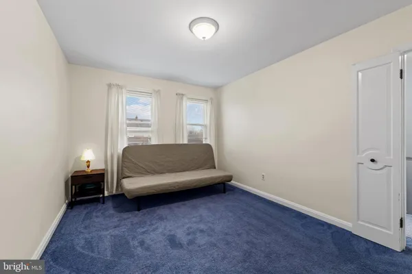 a living room with a couch and a dresser