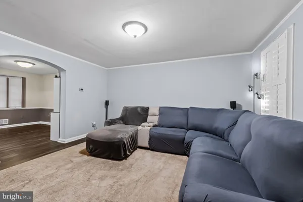 a living room with furniture a couch and wooden floor