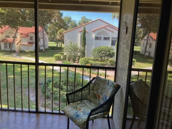 a view of a porch with furniture and backyard