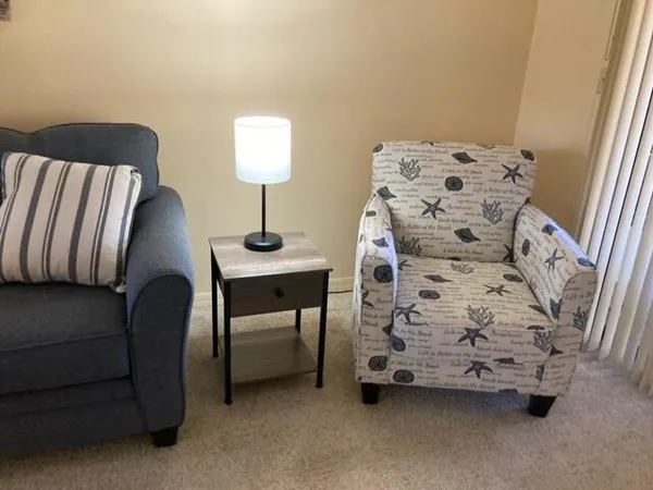 a bedroom with a bed and a chair