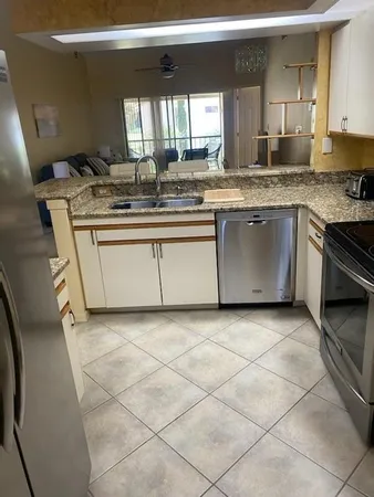 a kitchen with a sink a stove cabinets and counter space