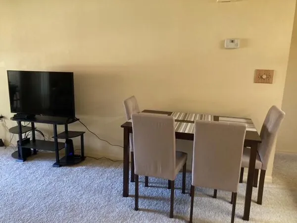 a view of a livingroom with furniture and a flat screen tv