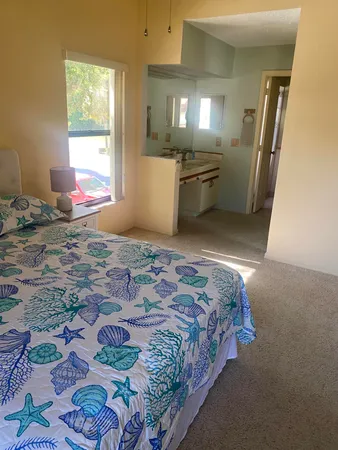 a bedroom with a bed and glass windows