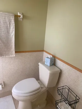 a white toilet sitting next to a bathroom sink