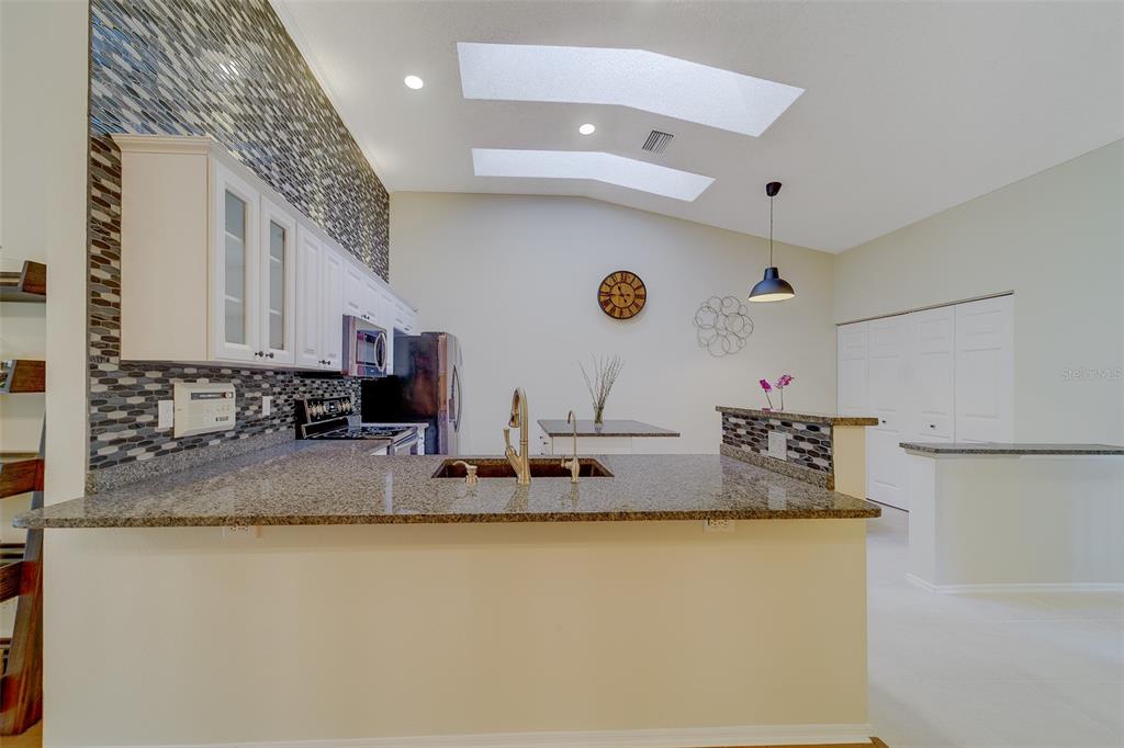 4405 Connery Court Palm Harbor, FL 34685 - Photo 12 of 51 a bathroom with a granite countertop sink mirror and vanity