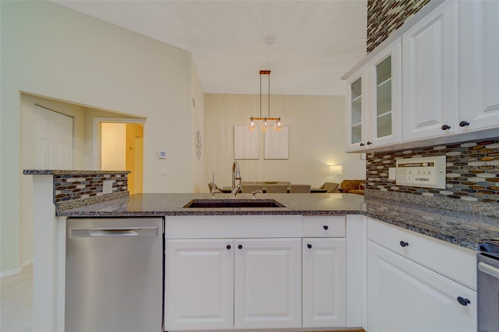 4405 Connery Court Palm Harbor, FL 34685 - Photo 13 of 51 a kitchen with stainless steel appliances granite countertop a sink and cabinets
