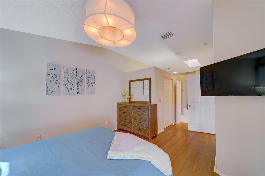 4405 Connery Court Palm Harbor, FL 34685 - Photo 19 of 51 a bedroom with a bed and a flat screen tv