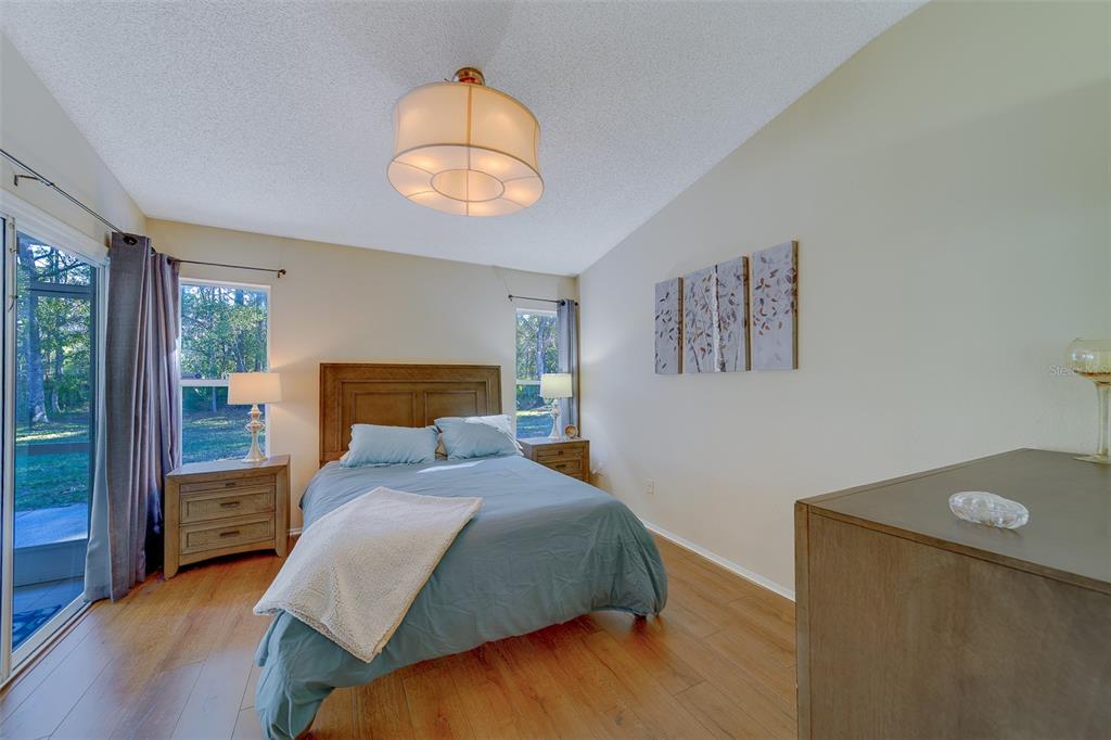 4405 Connery Court Palm Harbor, FL 34685 - Photo 21 of 51 a bedroom with a bed and a painting on the wall