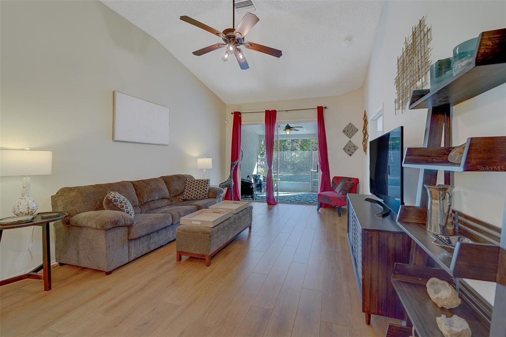 4405 Connery Court Palm Harbor, FL 34685 - Photo 5 of 51 a living room with furniture a ceiling fan and a wooden floor