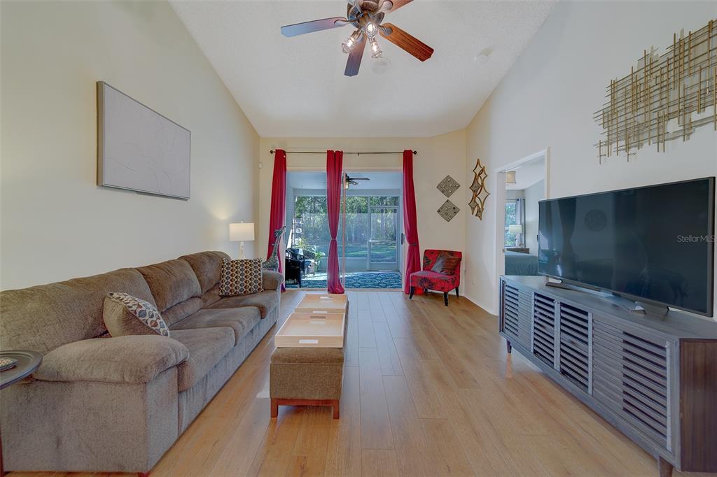 4405 Connery Court Palm Harbor, FL 34685 - Photo 7 of 51 a living room with furniture and a flat screen tv