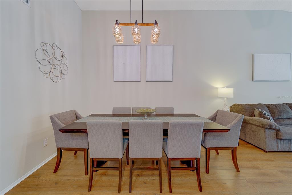 4405 Connery Court Palm Harbor, FL 34685 - Photo 9 of 51 a view of a dining room with furniture and wooden floor