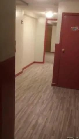 a view of a hallway with wooden floor and entryway