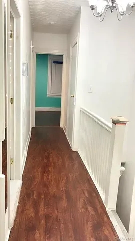 a bedroom with a bed and a view of kitchen