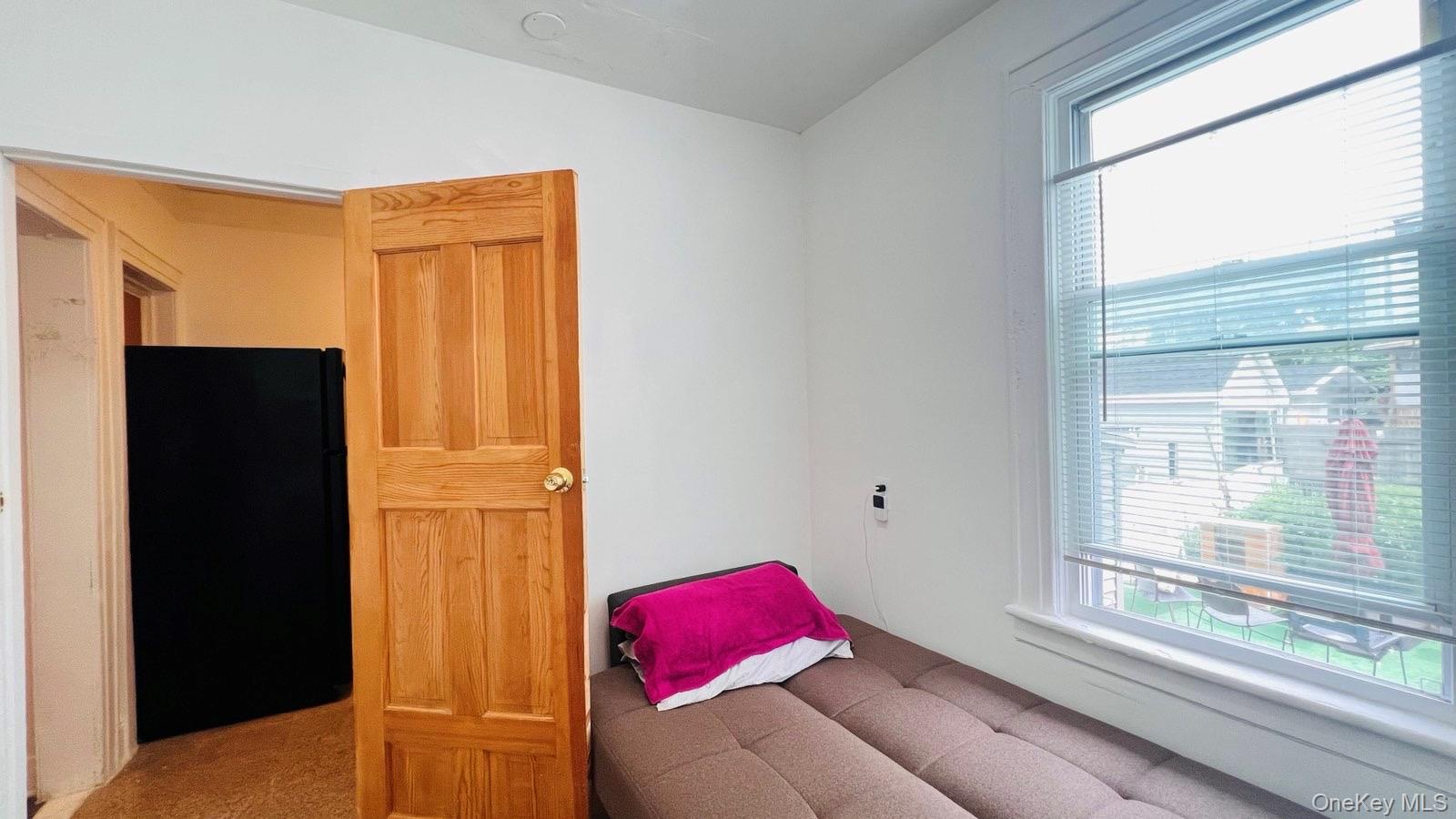 175-08 93rd Avenue Queens, NY 11433 - Photo 6 of 17 a bedroom with a bed and a window