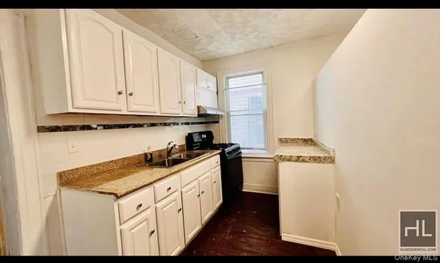 a view of a kitchen from a hallway