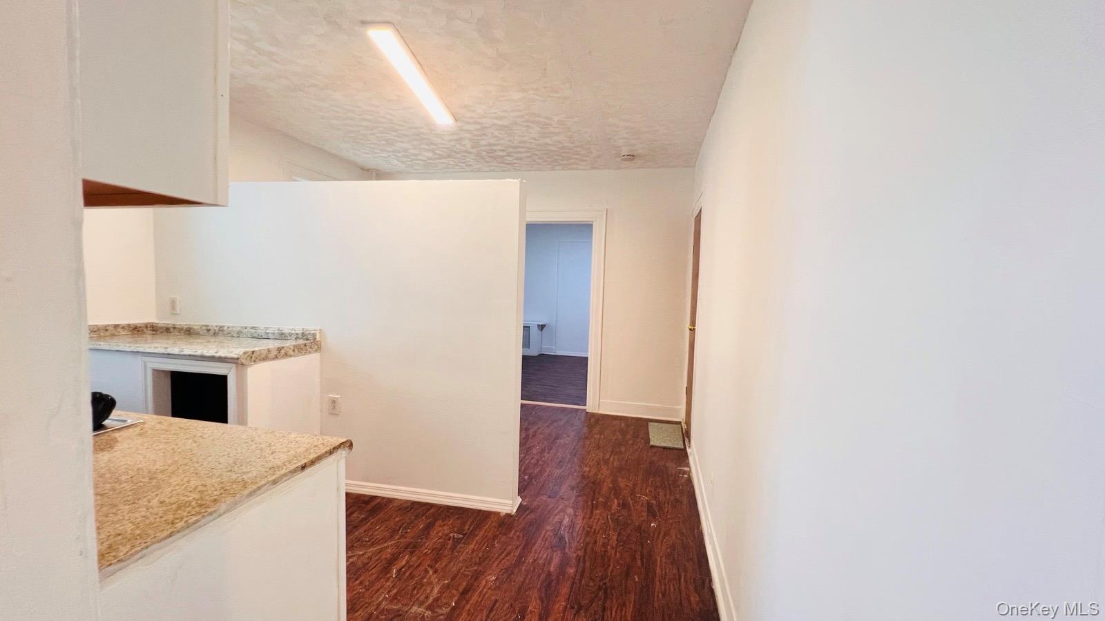 175-08 93rd Avenue Queens, NY 11433 - Photo 8 of 17 a view of a kitchen from a hallway