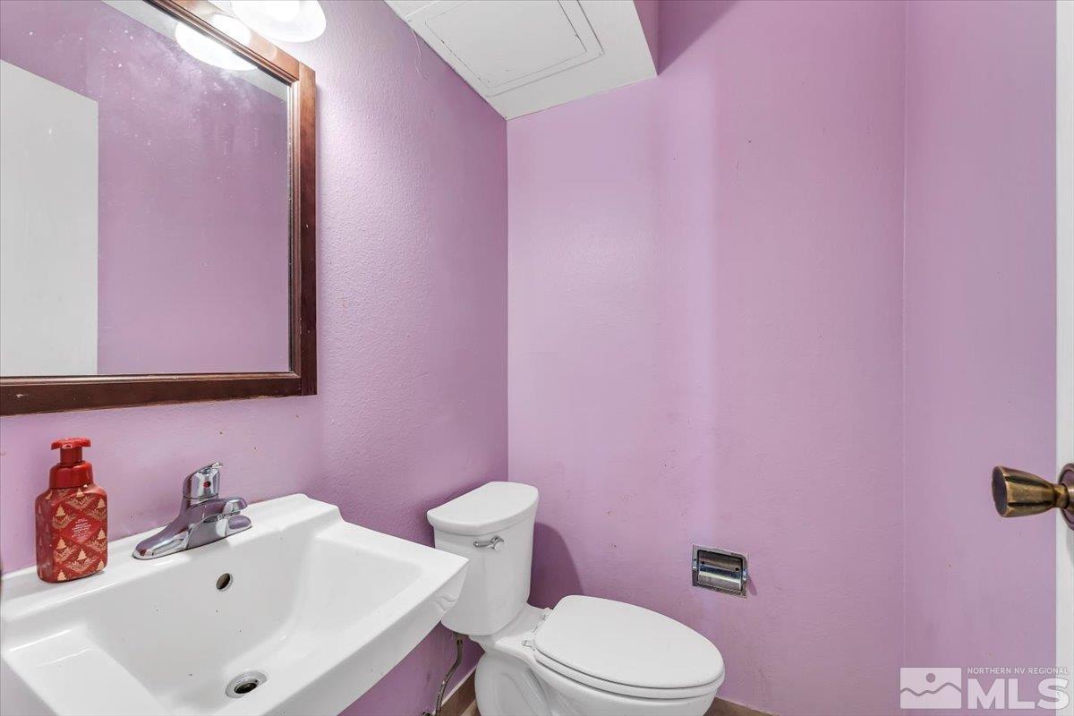 1402 East 9th Street, Unit 11 Reno, NV 89512 - Photo 16 of 25 a bathroom with a sink mirror and toilet